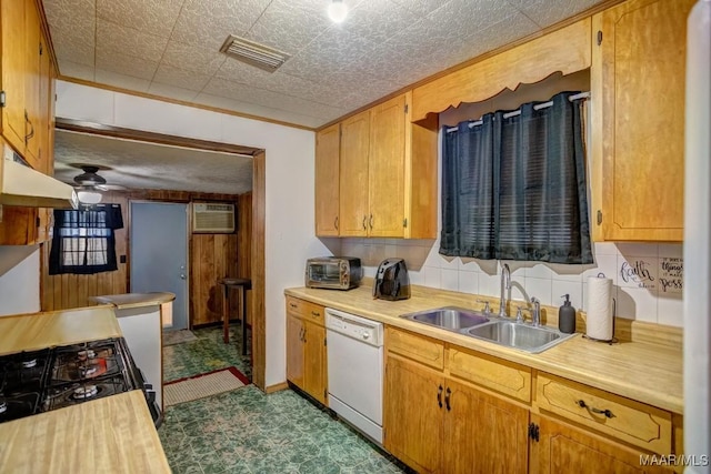 kitchen featuring visible vents, an AC wall unit, light countertops, white dishwasher, and a sink