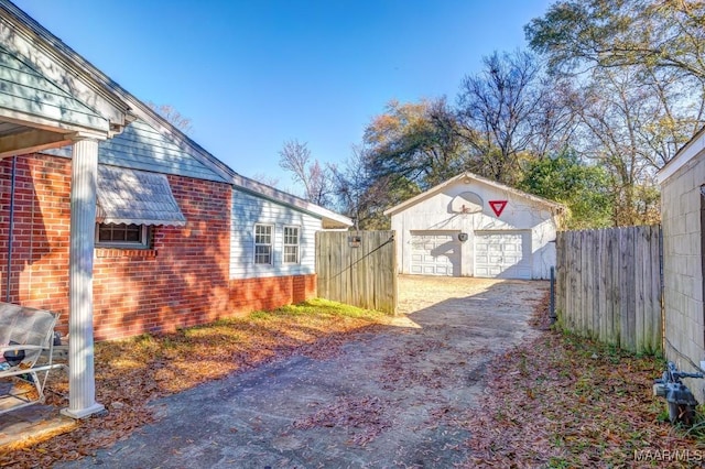 view of yard with a garage, an outdoor structure, and fence