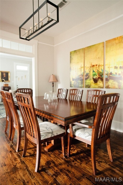 dining area featuring wood finished floors and visible vents