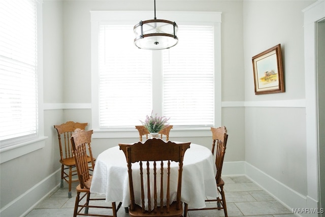 dining space with light tile patterned floors and baseboards