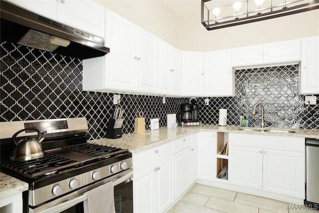 kitchen with tasteful backsplash, under cabinet range hood, appliances with stainless steel finishes, white cabinetry, and a sink