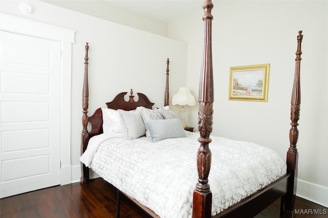 bedroom featuring dark wood-type flooring and baseboards