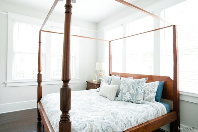 bedroom featuring baseboards and wood finished floors