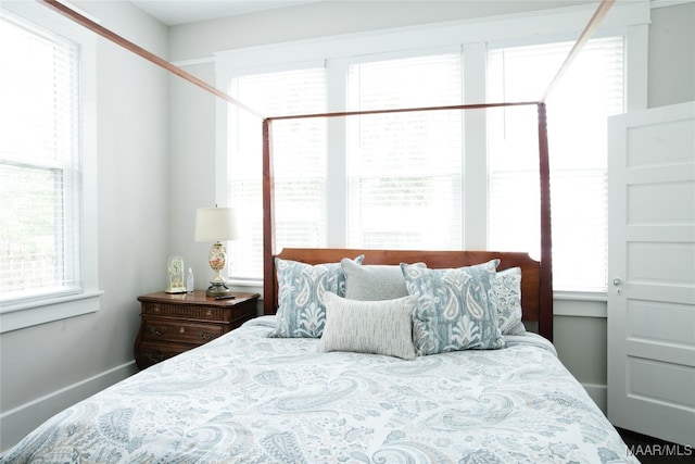 bedroom featuring multiple windows and baseboards