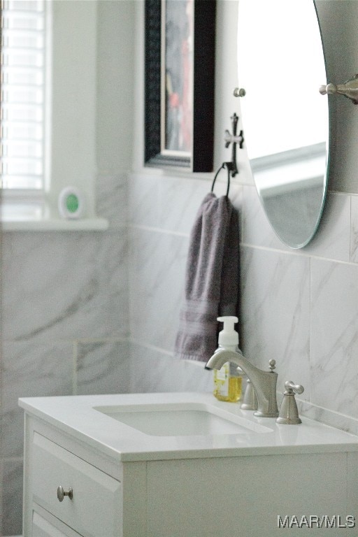 bathroom with tasteful backsplash, vanity, and tile walls