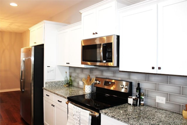 kitchen featuring decorative backsplash, white cabinets, and appliances with stainless steel finishes