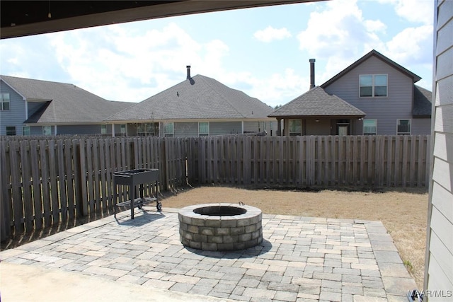 view of patio featuring a fire pit and a fenced backyard