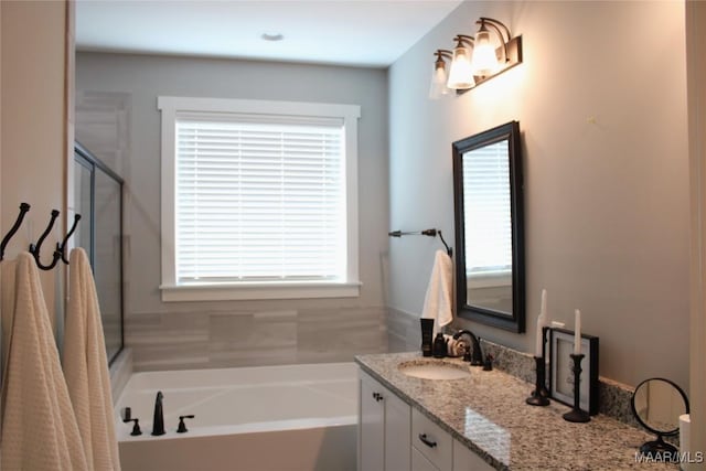 bathroom with vanity, a bath, and a stall shower