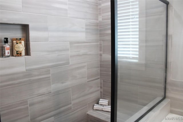 bathroom with a tile shower