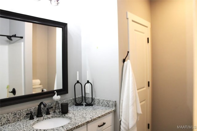 bathroom featuring toilet and vanity