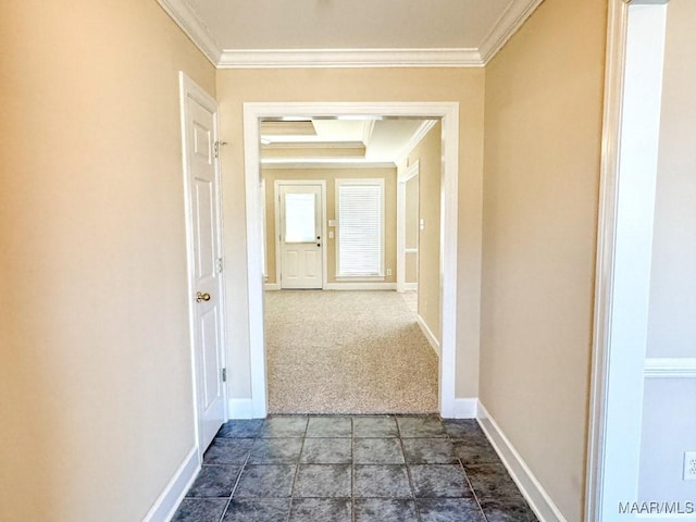 hall featuring crown molding and baseboards