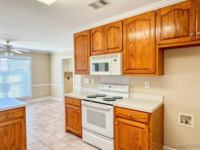 kitchen featuring white appliances, light countertops, visible vents, and brown cabinets