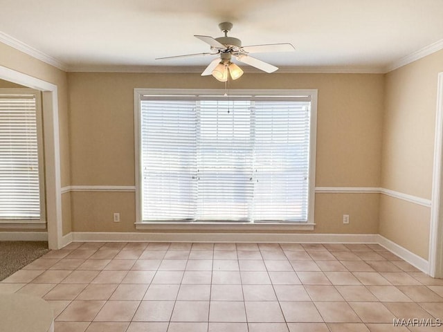 unfurnished room featuring a ceiling fan, baseboards, and ornamental molding