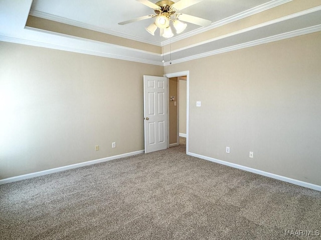 carpeted spare room with baseboards and crown molding