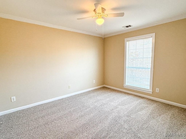 empty room featuring visible vents, ceiling fan, baseboards, carpet, and ornamental molding