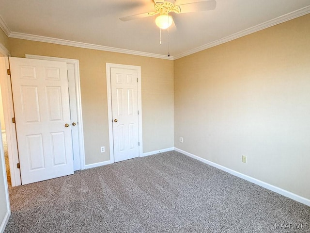 unfurnished bedroom with baseboards, crown molding, carpet, and a ceiling fan