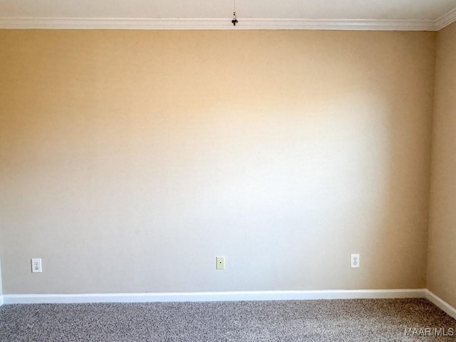 empty room with crown molding, baseboards, and carpet floors