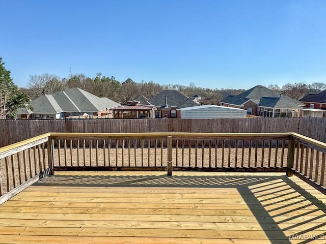 deck with a residential view and a fenced backyard