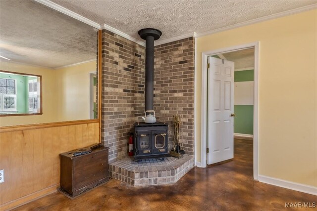 unfurnished living room featuring concrete flooring, a textured ceiling, a wood stove, and crown molding