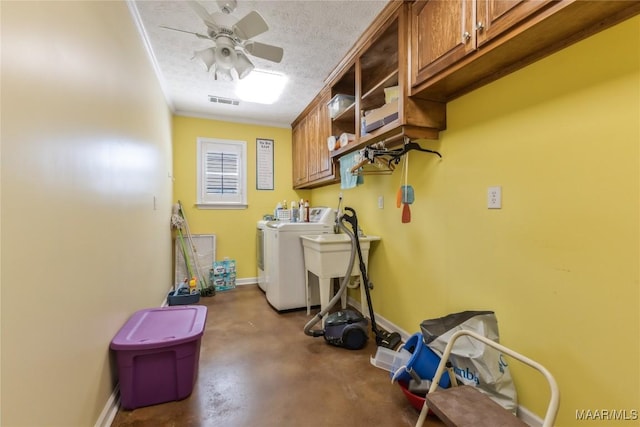 laundry room with visible vents, cabinet space, a textured ceiling, independent washer and dryer, and a ceiling fan