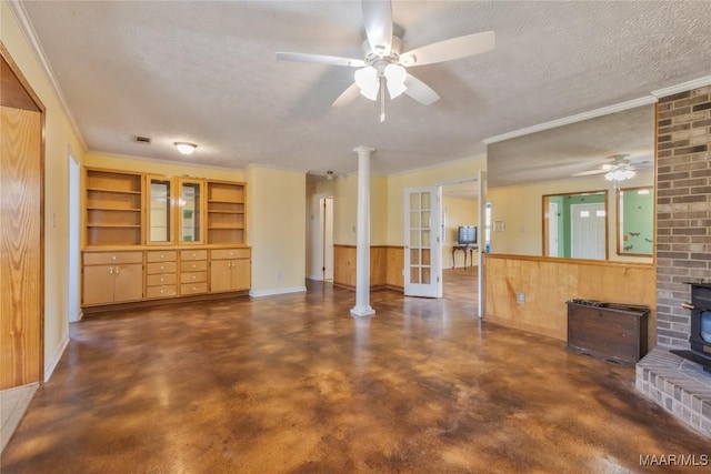 unfurnished living room featuring concrete flooring, french doors, a wood stove, a textured ceiling, and a ceiling fan