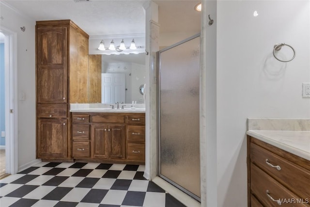 bathroom with tile patterned floors, a stall shower, and vanity