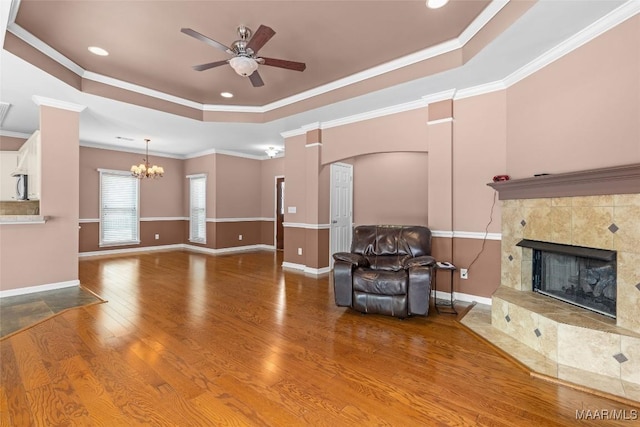 125 Greenfield Pl, Wetumpka, AL 36093 - unfurnished living room with ceiling fan with notable chandelier, a raised ceiling, crown molding, and wood finished floors
