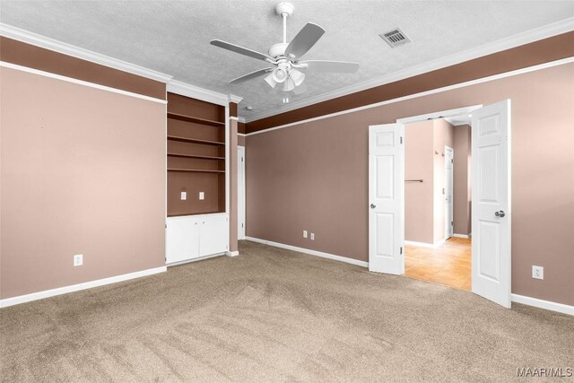 125 Greenfield Pl, Wetumpka, AL 36093 - unfurnished bedroom with visible vents, baseboards, ornamental molding, carpet floors, and a textured ceiling