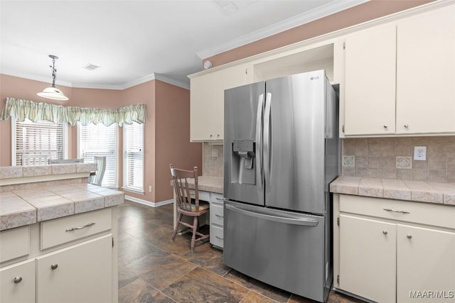 125 Greenfield Pl, Wetumpka, AL 36093 - kitchen with visible vents, backsplash, stainless steel fridge with ice dispenser, ornamental molding, and hanging light fixtures