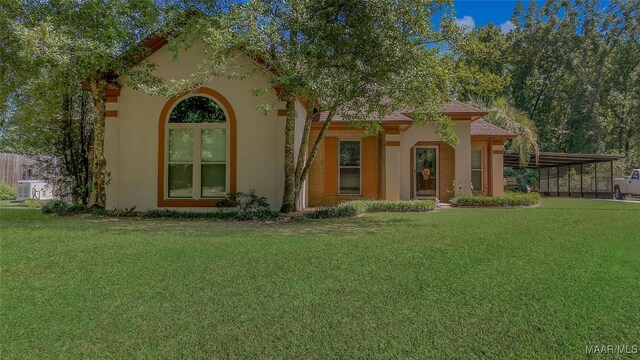 125 Greenfield Pl, Wetumpka, AL 36093 - mediterranean / spanish home with stucco siding, a front lawn, and an attached carport