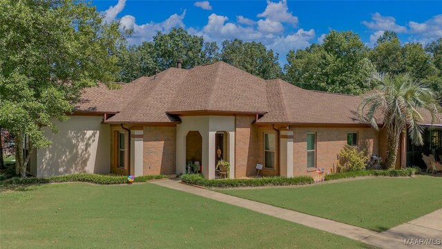 125 Greenfield Pl, Wetumpka, AL 36093 - view of front of house with a front yard, brick siding, and roof with shingles