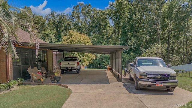 125 Greenfield Pl, Wetumpka, AL 36093 - view of vehicle parking featuring an attached carport, concrete driveway, and fence