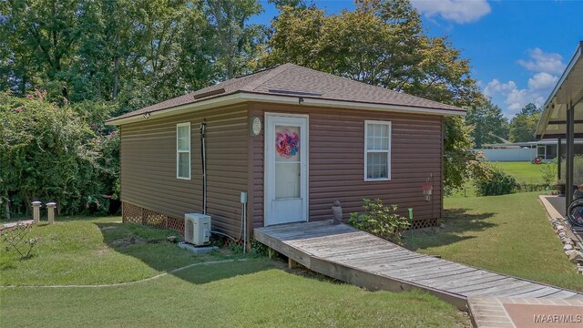 125 Greenfield Pl, Wetumpka, AL 36093 - view of front of house with ac unit, an outdoor structure, a front yard, and roof with shingles