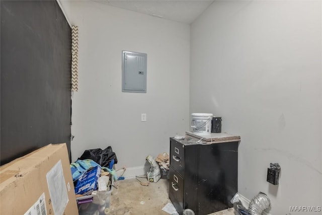 interior space featuring electric panel, baseboards, and concrete flooring