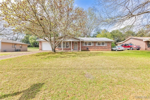 single story home featuring brick siding, an attached garage, and a front yard