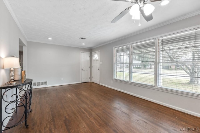 entryway with visible vents, baseboards, ornamental molding, wood finished floors, and a ceiling fan