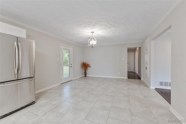 interior space featuring visible vents, baseboards, a textured ceiling, and ornamental molding