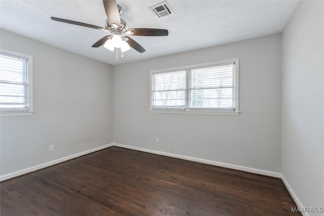 unfurnished room featuring ceiling fan, visible vents, baseboards, and wood finished floors