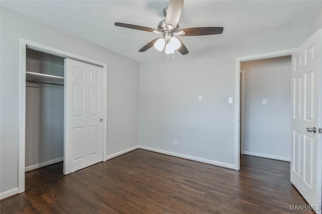 unfurnished bedroom featuring a closet, baseboards, wood finished floors, and a ceiling fan