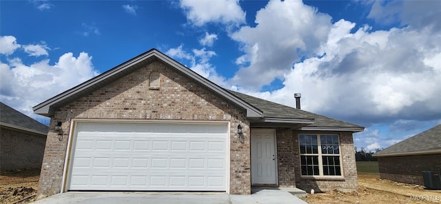 single story home featuring brick siding, concrete driveway, and an attached garage