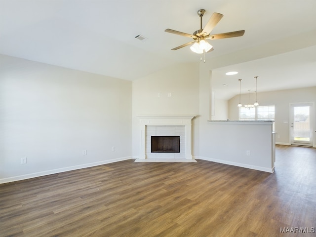 unfurnished living room with baseboards, a fireplace, ceiling fan, and dark wood-style flooring