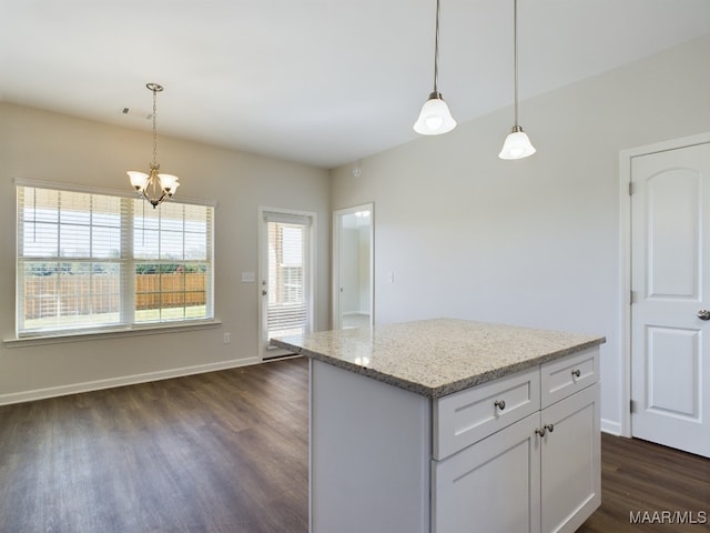 kitchen with pendant lighting, light stone counters, a notable chandelier, white cabinets, and dark wood-style flooring