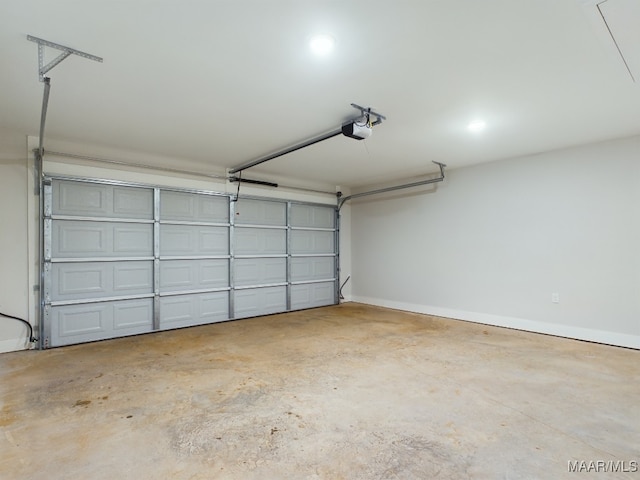 garage with baseboards and a garage door opener