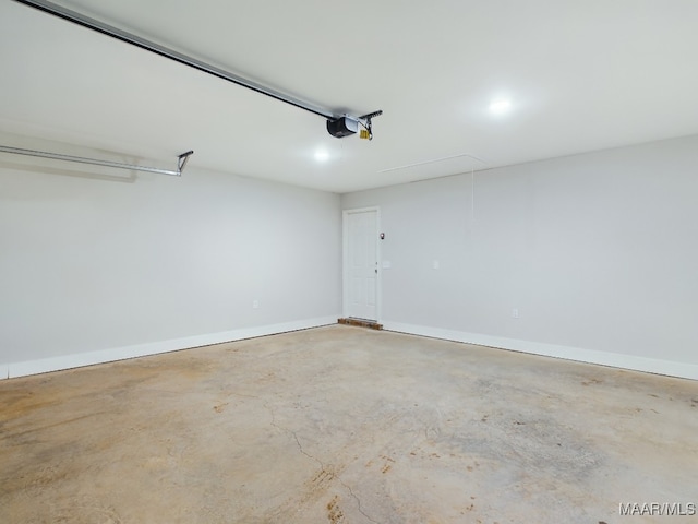 garage with baseboards and a garage door opener