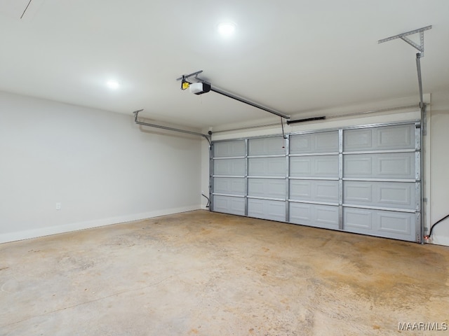 garage featuring a garage door opener and baseboards