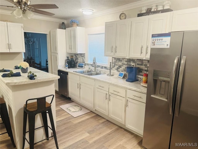 kitchen with dishwashing machine, stainless steel fridge with ice dispenser, ornamental molding, a sink, and light countertops