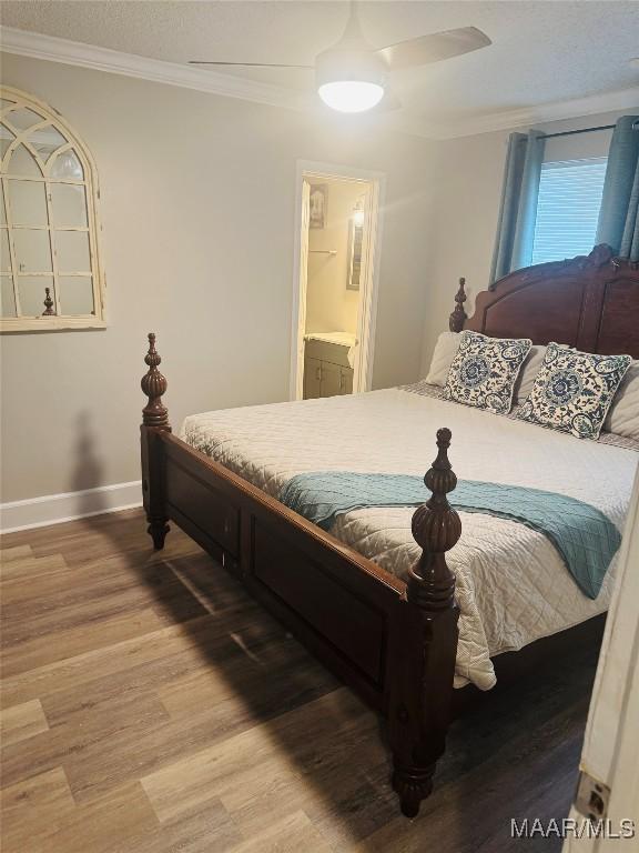 bedroom featuring a ceiling fan, light wood-type flooring, baseboards, and ornamental molding