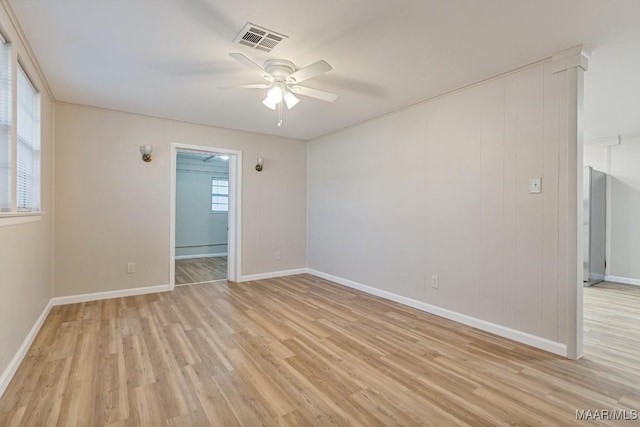 unfurnished room with visible vents, ceiling fan, baseboards, and light wood-style floors