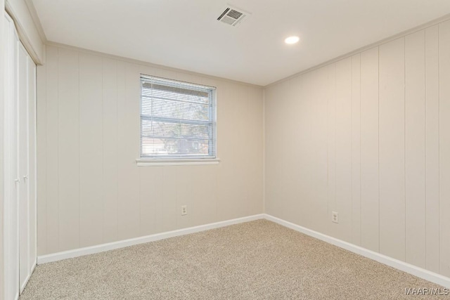 carpeted empty room with visible vents, recessed lighting, and baseboards