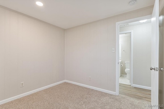 carpeted spare room featuring baseboards